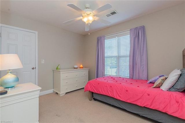 bedroom with light colored carpet, visible vents, ceiling fan, and baseboards