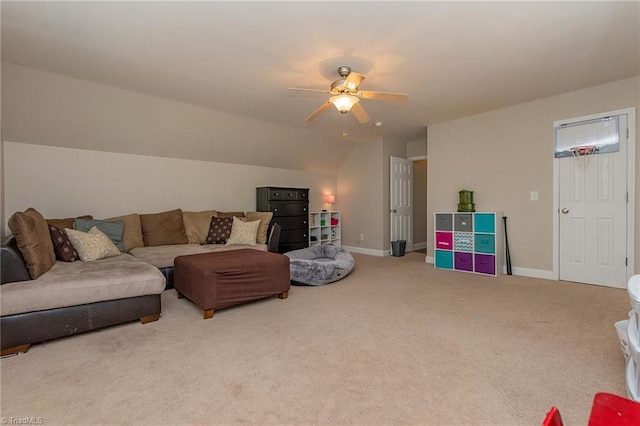 living area featuring lofted ceiling, carpet floors, a ceiling fan, and baseboards