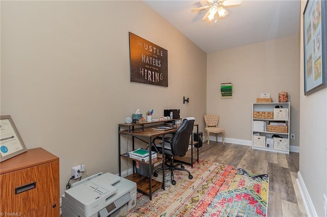 office area featuring a ceiling fan, baseboards, and wood finished floors