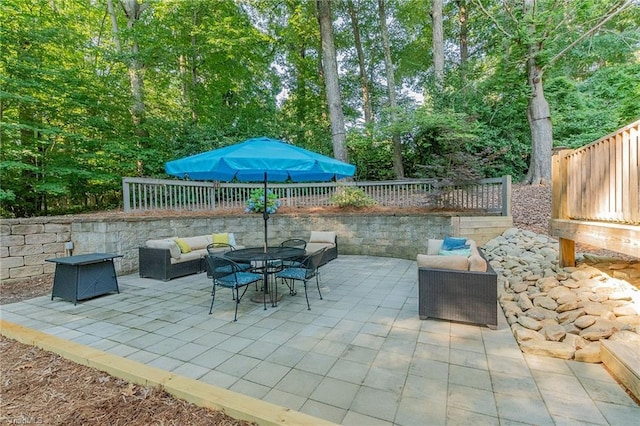 view of patio with outdoor dining area, a fenced backyard, and an outdoor hangout area