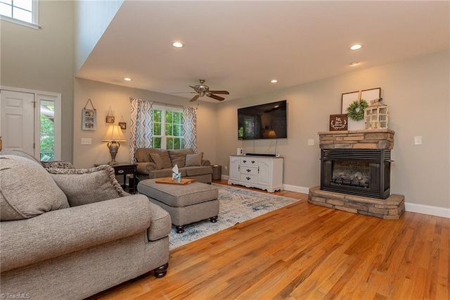 living area featuring a fireplace, recessed lighting, ceiling fan, wood finished floors, and baseboards