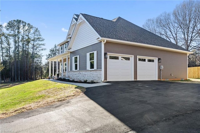 view of side of property with a yard and a garage