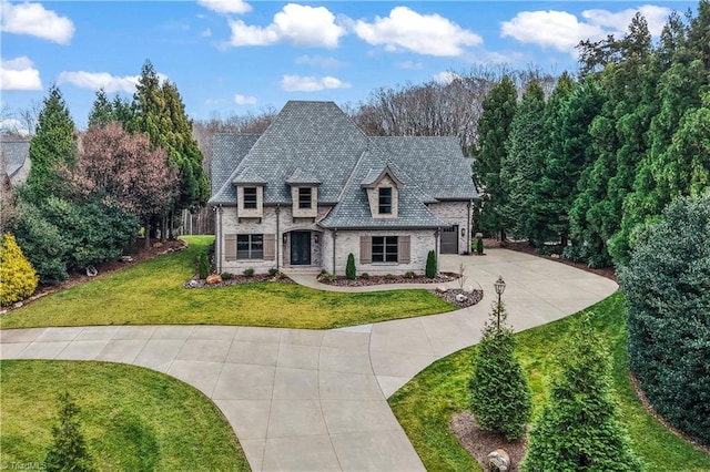 view of front of house with a garage and a front yard