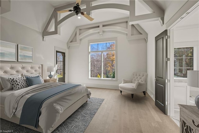 bedroom with ceiling fan, high vaulted ceiling, and light hardwood / wood-style floors