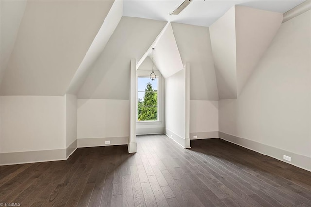 bonus room featuring vaulted ceiling, dark hardwood / wood-style floors, and ceiling fan