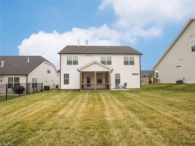 back of house featuring cooling unit, fence, a lawn, and a sunroom