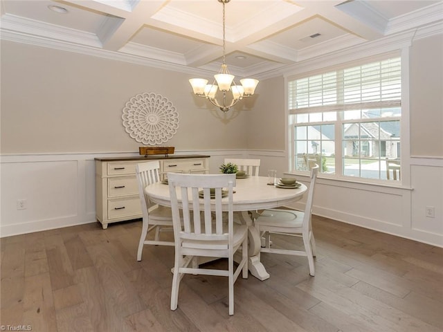 dining area with beam ceiling, light wood-type flooring, visible vents, and a chandelier