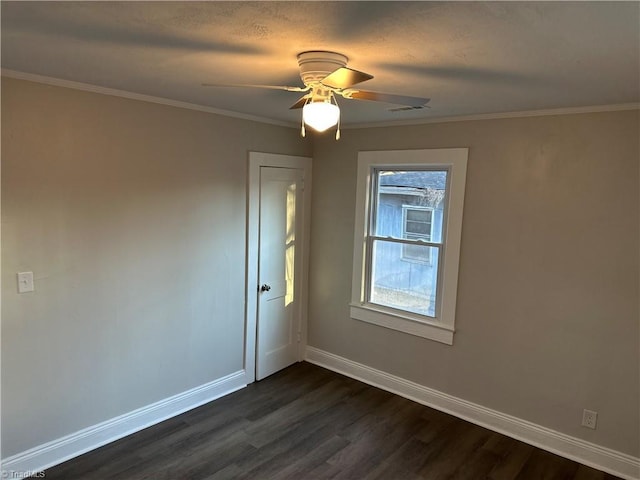 unfurnished room featuring visible vents, baseboards, ceiling fan, ornamental molding, and dark wood-style flooring