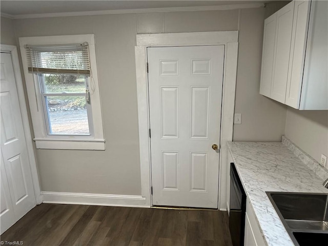 kitchen featuring white cabinets, dishwasher, dark wood-style floors, crown molding, and a sink