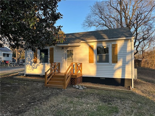 view of front of home with a shingled roof and crawl space