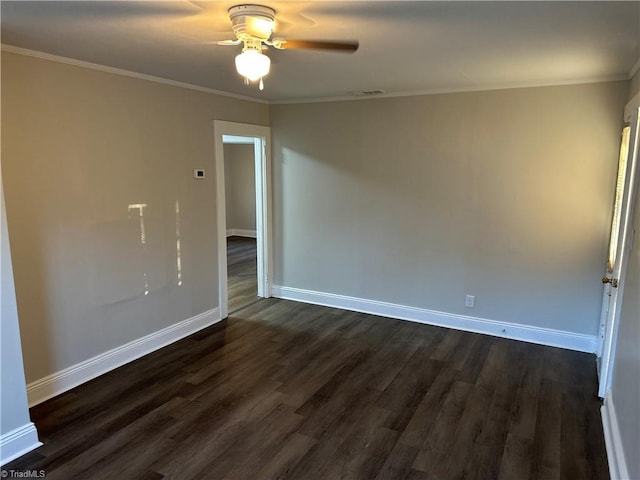 unfurnished room featuring baseboards, ornamental molding, and dark wood-style flooring