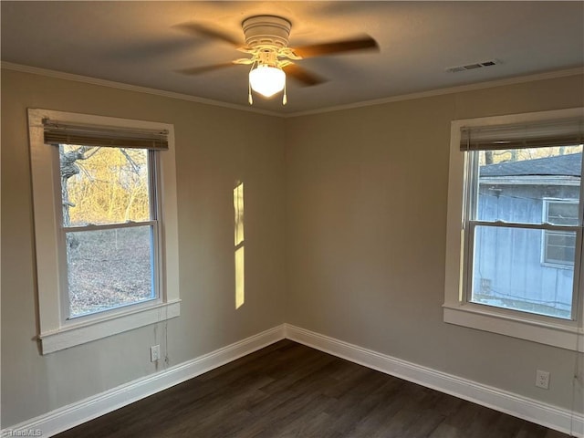 unfurnished room featuring crown molding, visible vents, dark wood-type flooring, ceiling fan, and baseboards