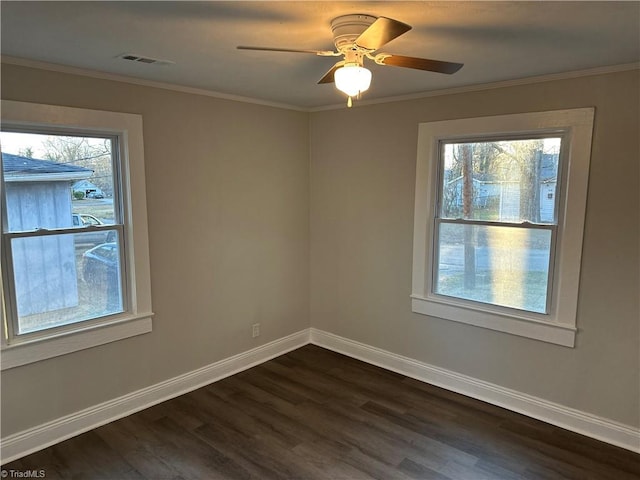 unfurnished room with ceiling fan, dark wood-style flooring, visible vents, baseboards, and ornamental molding