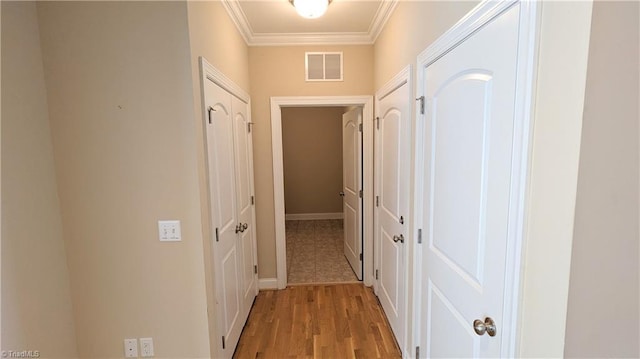 corridor featuring crown molding and light wood-type flooring