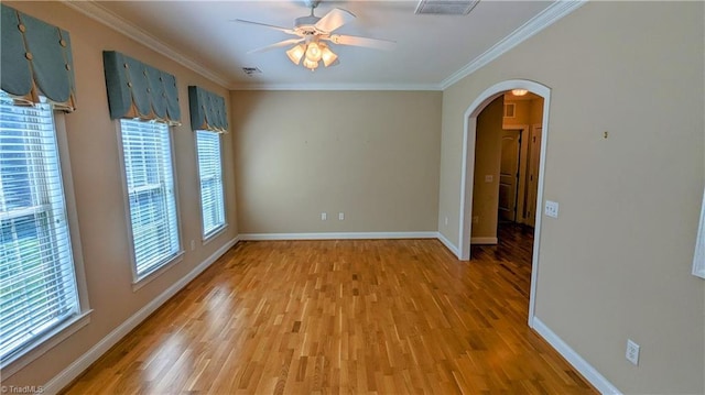 empty room featuring crown molding, hardwood / wood-style floors, and ceiling fan