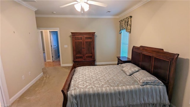 carpeted bedroom with ceiling fan and crown molding