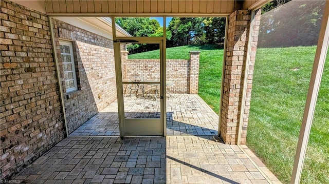 doorway featuring brick wall