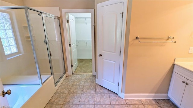 bathroom featuring tile patterned floors, vanity, and plus walk in shower