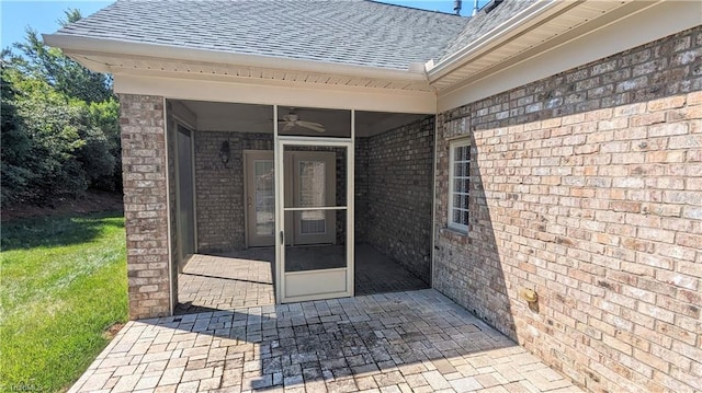 entrance to property featuring a patio and ceiling fan