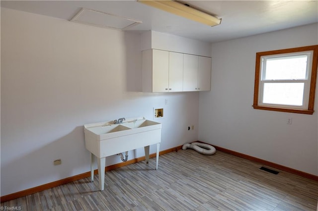 laundry room with hookup for an electric dryer, washer hookup, visible vents, baseboards, and cabinet space