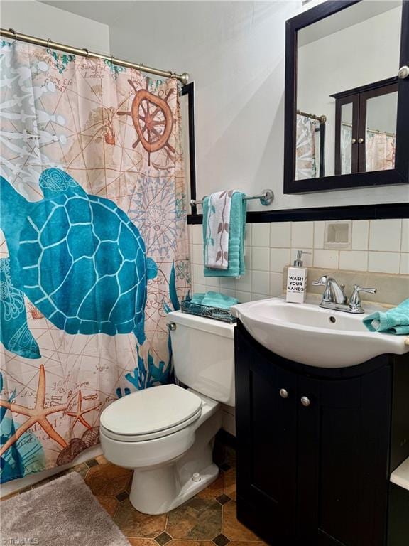 1500 Brent Ct Unit 9-B, Burlington, NC 27215 - bathroom with vanity, toilet, and tile walls