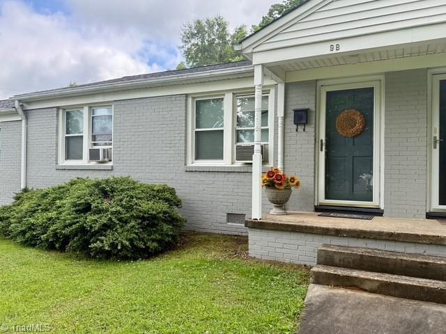 1500 Brent Ct Unit 9-B, Burlington, NC 27215 - doorway to property with brick siding, cooling unit, and a yard