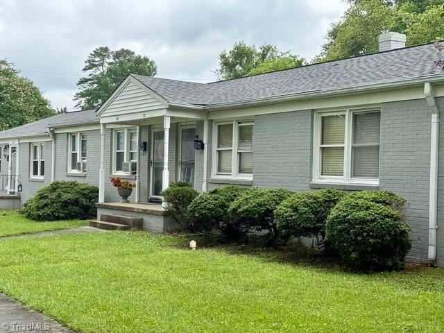 1500 Brent Ct Unit 9-B, Burlington, NC 27215 - single story home featuring brick siding, a front yard, a chimney, and a shingled roof
