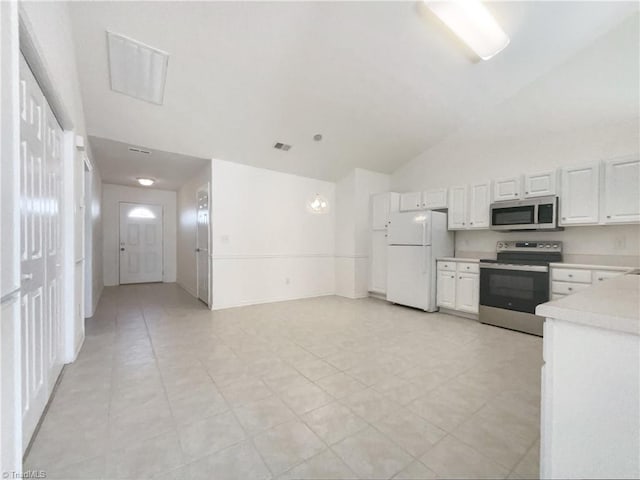 kitchen featuring visible vents, light countertops, lofted ceiling, appliances with stainless steel finishes, and white cabinets