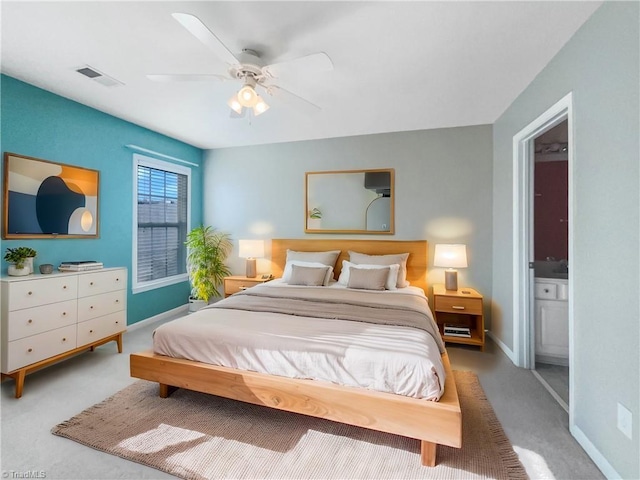 bedroom featuring visible vents, baseboards, carpet, and ensuite bath