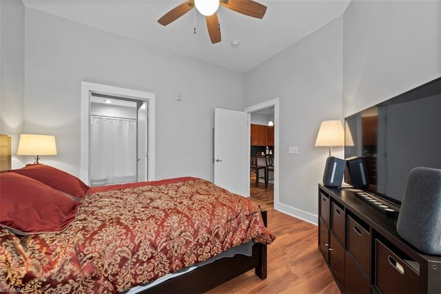 bedroom with light hardwood / wood-style flooring, ceiling fan, and vaulted ceiling