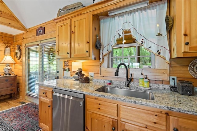 201 Cherokee Cir, Jefferson, NC 28640 - kitchen featuring stainless steel dishwasher, a sink, wood walls, lofted ceiling, and light stone counters