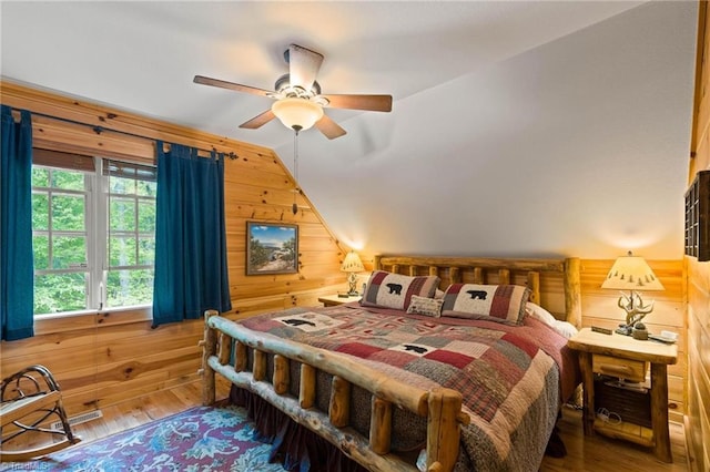 201 Cherokee Cir, Jefferson, NC 28640 - bedroom featuring wood walls, vaulted ceiling, wood finished floors, and a ceiling fan