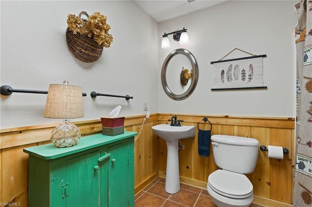 201 Cherokee Cir, Jefferson, NC 28640 - bathroom featuring a wainscoted wall, tile patterned floors, toilet, a sink, and wood walls