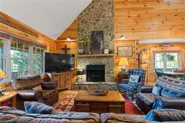 201 Cherokee Cir, Jefferson, NC 28640 - living room featuring wooden walls, high vaulted ceiling, wood finished floors, and a fireplace