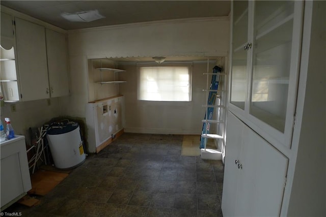 interior space with white cabinets and dark tile floors