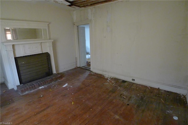 unfurnished living room with a fireplace and dark hardwood / wood-style floors