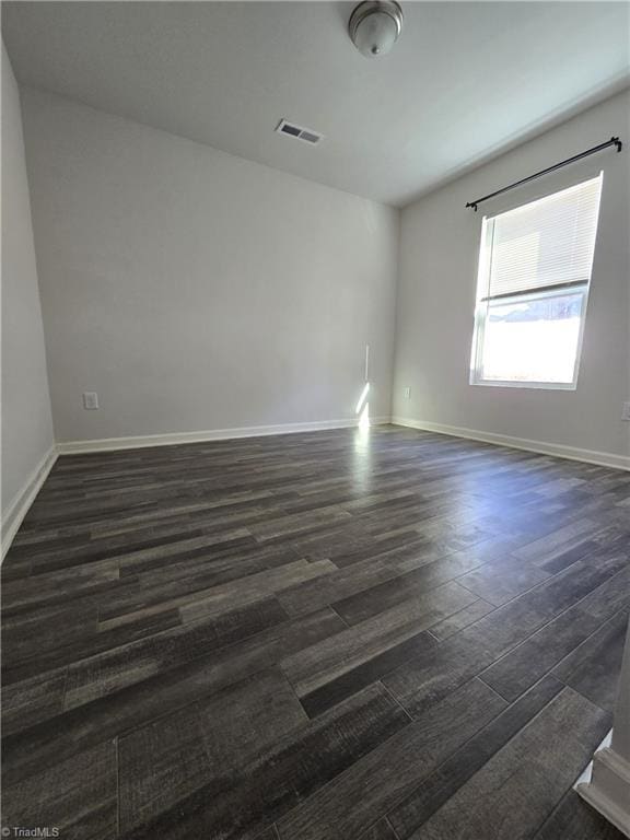 empty room featuring dark hardwood / wood-style floors