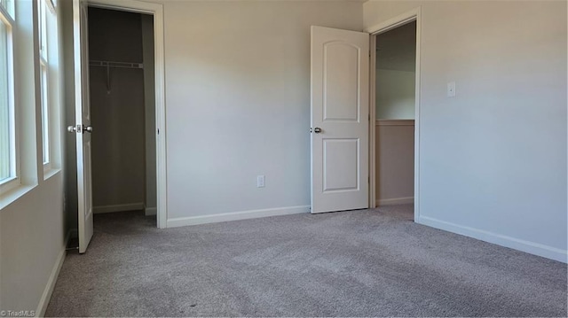 unfurnished bedroom with a closet and carpet flooring