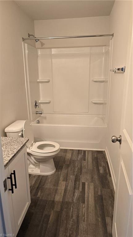 full bathroom featuring toilet, tub / shower combination, wood-type flooring, and vanity