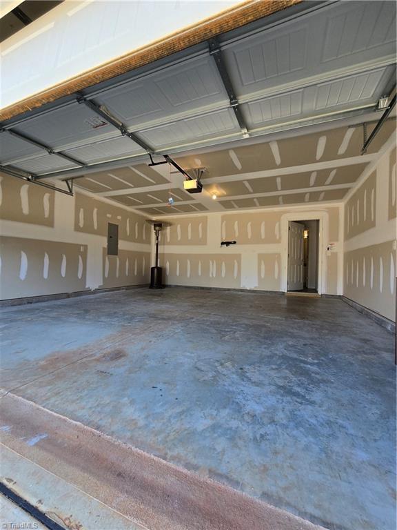 garage featuring a garage door opener and electric panel