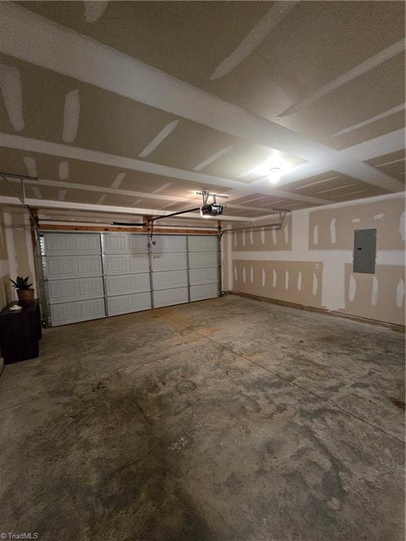 garage featuring a garage door opener and electric panel