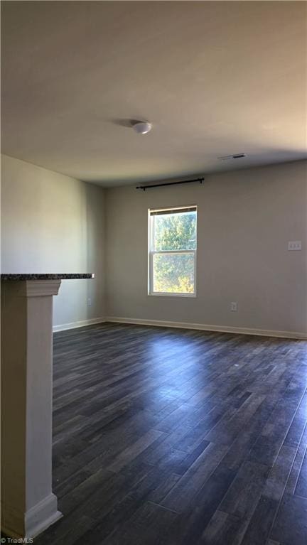 spare room featuring dark hardwood / wood-style floors