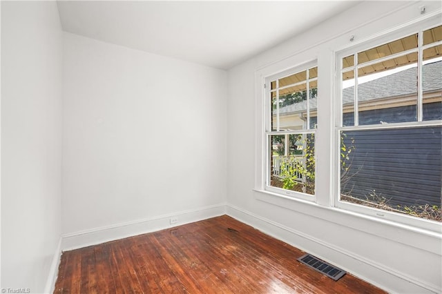 unfurnished room with hardwood / wood-style flooring