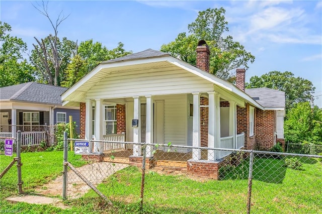 view of front of property with covered porch and a front yard