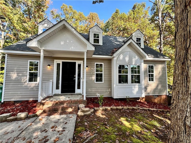 view of front of home with crawl space and a shingled roof