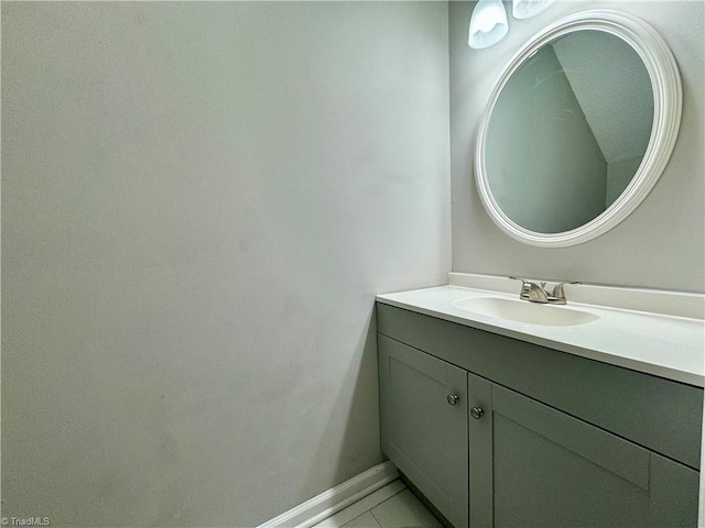 bathroom with vanity, tile patterned flooring, and baseboards