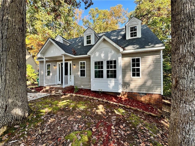 view of front of house featuring a porch, crawl space, and roof with shingles