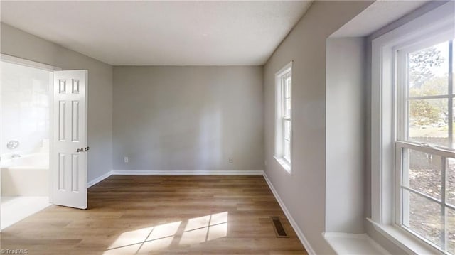 unfurnished room featuring wood finished floors and baseboards