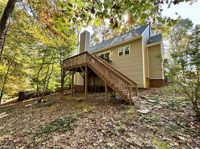 rear view of property featuring a wooden deck