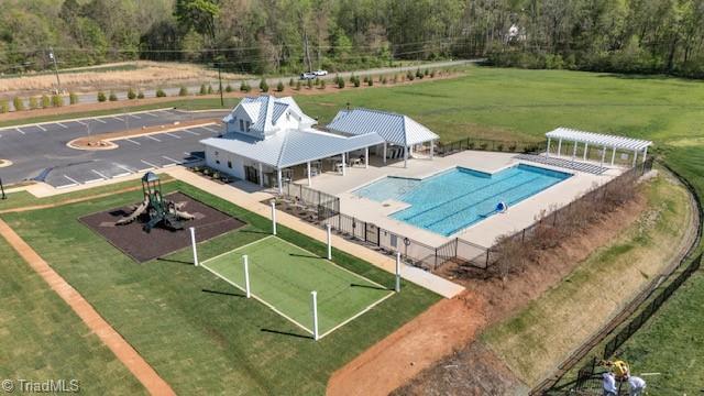 aerial view of property and surrounding area featuring a pool